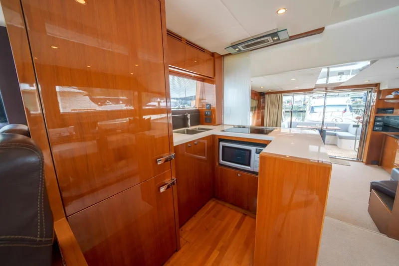 Slide: The Image of Luxurious kitchen interior of 2012 Princess Flybridge 60 Motor Yacht with wood finish. - 23