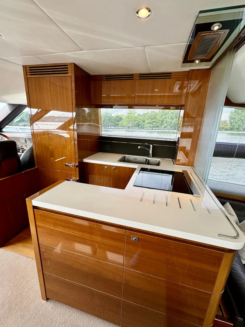 Slide: The Image of Luxurious kitchen interior of 2012 Princess Flybridge 60 Motor Yacht with wood cabinetry. - 25