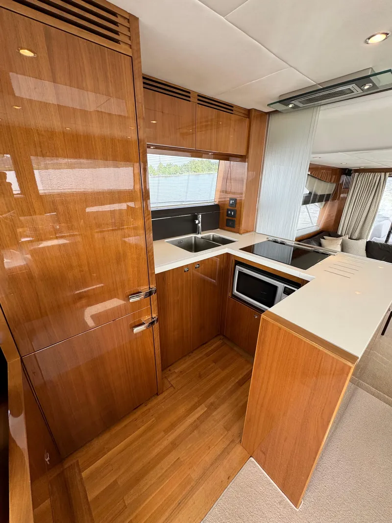 Slide: The Image of Luxurious kitchen interior of 2012 Princess Flybridge 60 Motor Yacht with wood finish. - 29