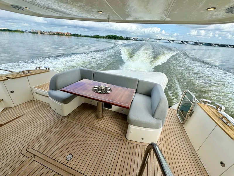 Slide: The Image of Princess Flybridge 60 Motor Yacht 2012, elegant deck seating, cruising on calm waters. - 3