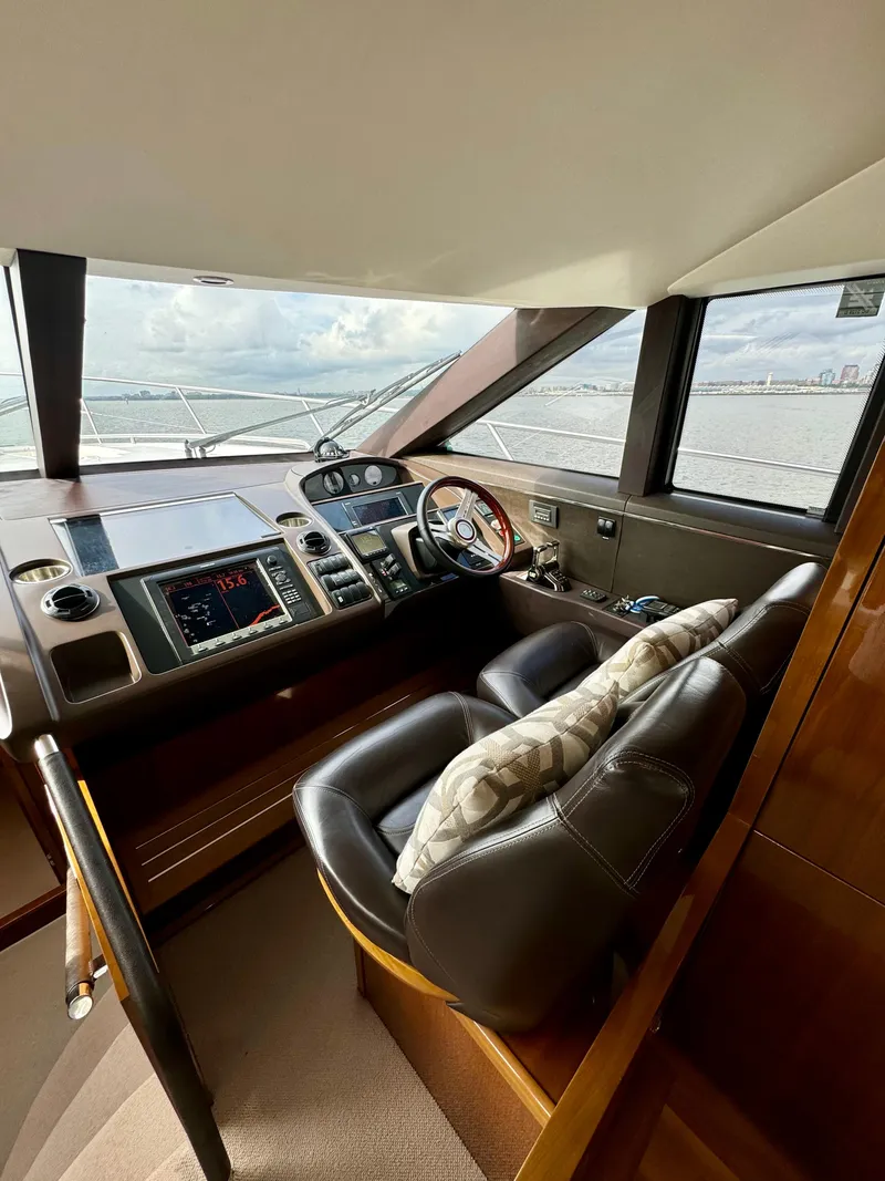 Slide: The Image of Luxurious 2012 Princess Flybridge 60 Motor Yacht helm with leather seating and advanced controls. - 31