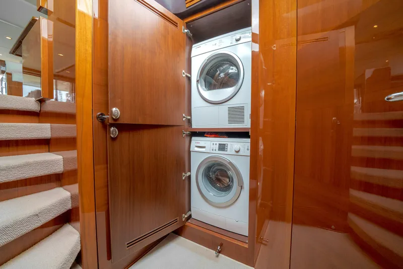 Slide: The Image of Laundry area in 2012 Princess Flybridge 60 Motor Yacht with stacked washer and dryer. - 35