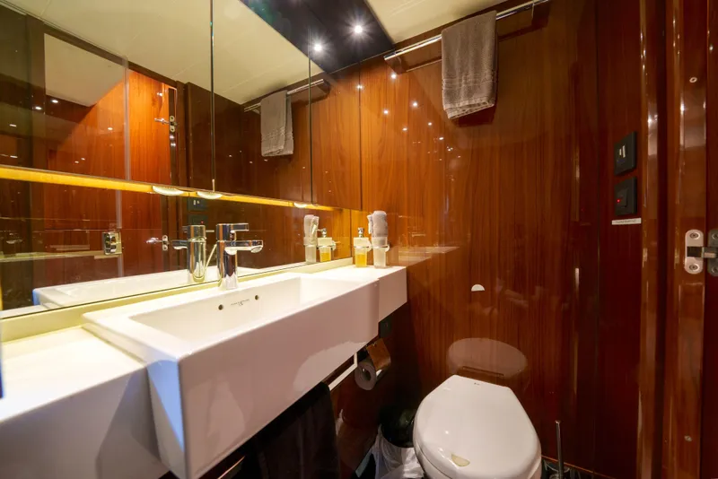 Slide: The Image of Luxurious bathroom in 2012 Princess Flybridge 60 Motor Yacht with modern fixtures and wood paneling. - 40
