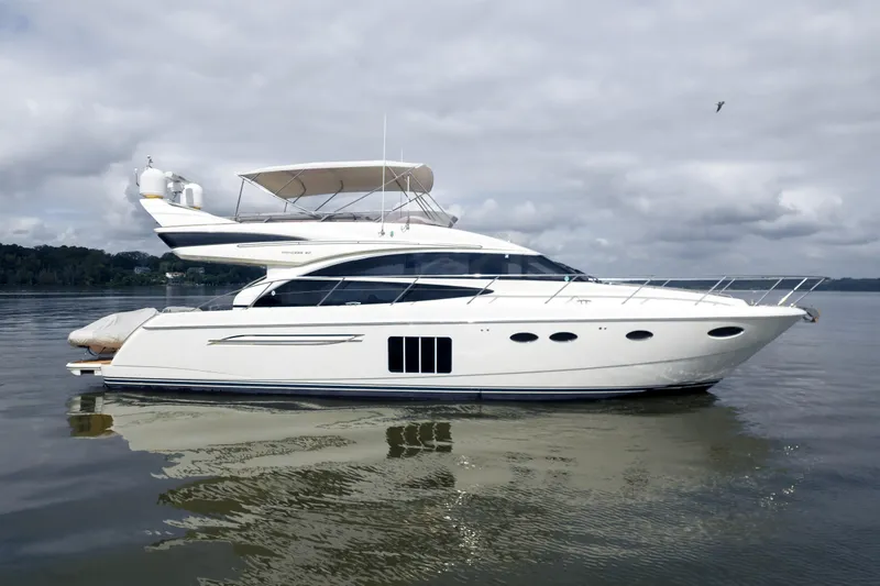 Slide: The Image of 2012 Princess Flybridge 60 Motor Yacht on calm water under cloudy sky. - 5
