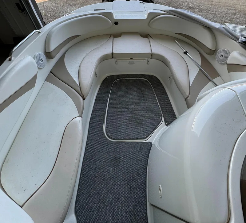 Slide: The Image of 2004 Glastron DX 215 boat interior with cushioned seating and carpeted floor. - 10