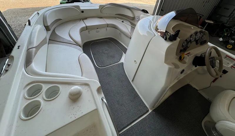 Slide: The Image of 2004 Glastron DX 215 boat interior with seating and dashboard. - 11