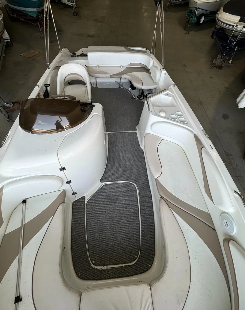 Slide: The Image of 2004 Glastron DX 215 boat interior with white and beige seating. - 13