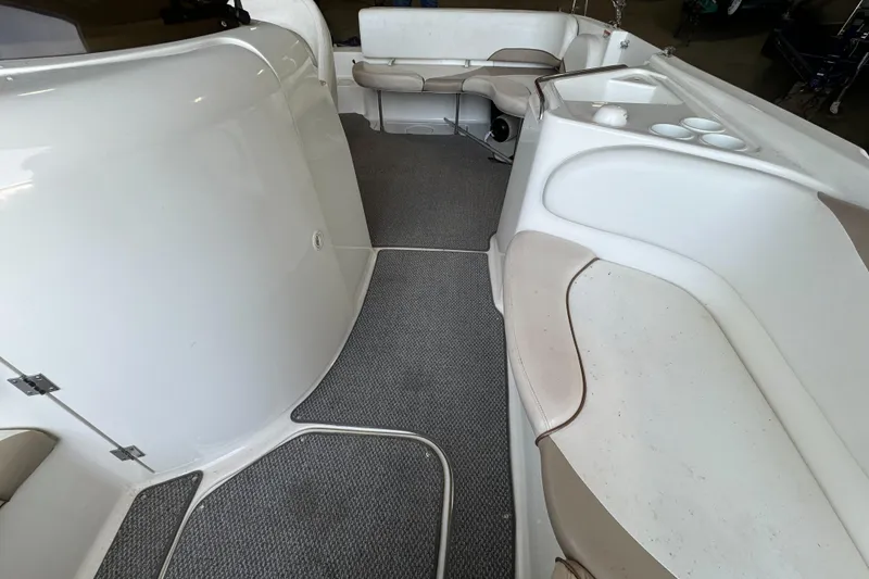 Slide: The Image of 2004 Glastron DX 215 boat interior with seating and carpeted floor. - 14
