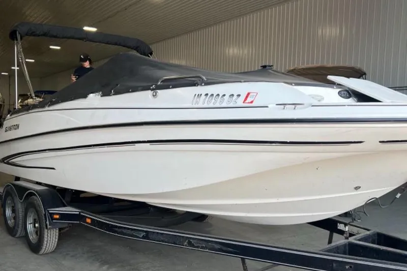 Slide: The Image of 2004 Glastron DX 215 boat on trailer in indoor storage. - 16