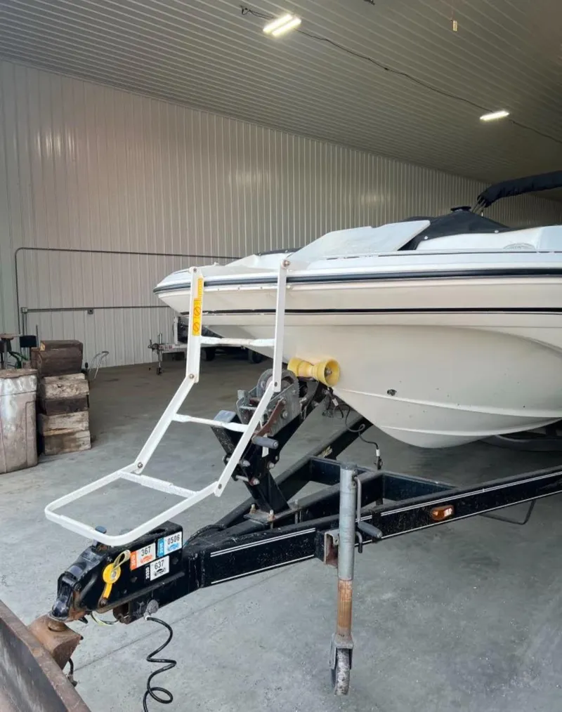 Slide: The Image of 2004 Glastron DX 215 boat on trailer in indoor storage facility. - 2