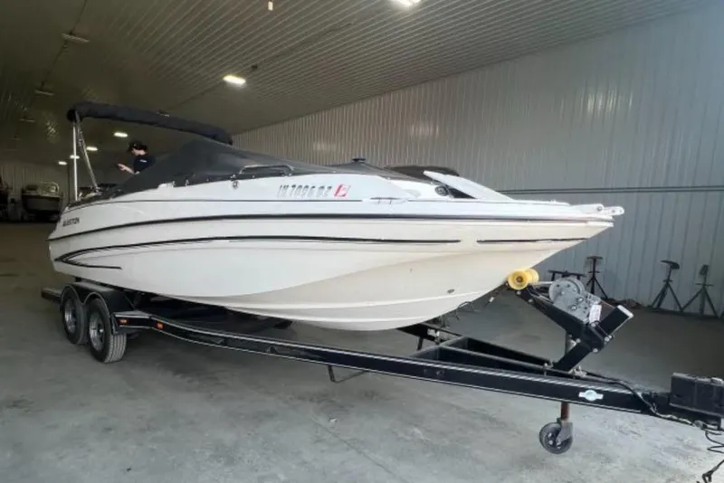 Slide: The Image of 2004 Glastron DX 215 boat on trailer in indoor storage facility. - 5