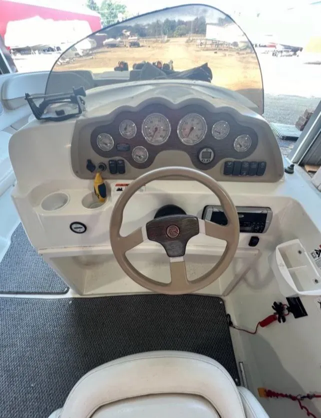 Slide: The Image of 2004 Glastron DX 215 boat dashboard with steering wheel and instrument panel. - 7