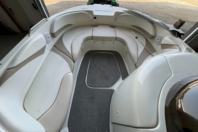 Slide: The Image of 2004 Glastron DX 215 boat interior with white seating and gray carpet. - 8