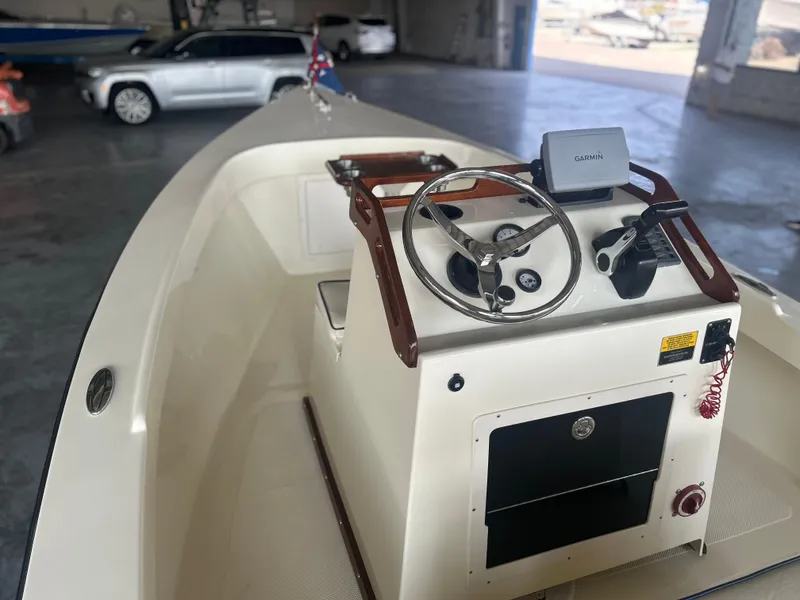 Slide: The Image of 2012 Seaway 18 Sportsman boat interior with steering wheel and Garmin device. - 13