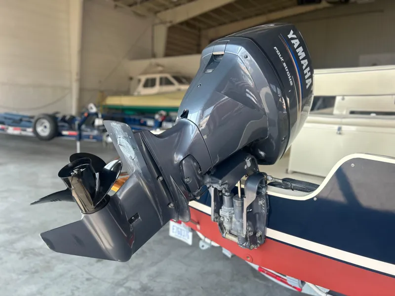 Slide: The Image of 2012 Seaway 18 Sportsman with Yamaha outboard motor in a garage setting. - 7