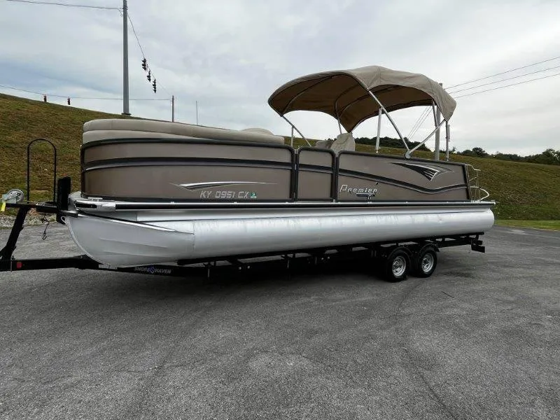Slide: The Image of 2021 Premier 250 Grand Majestic pontoon boat on trailer, parked outdoors. - 18
