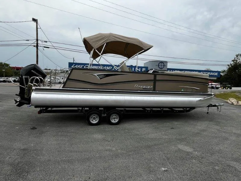 Slide: The Image of 2021 Premier 250 Grand Majestic pontoon boat on trailer, parked outdoors. - 20