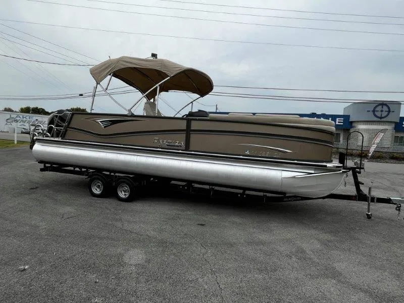 Slide: The Image of 2021 Premier 250 Grand Majestic pontoon boat on trailer, parked outdoors. - 22