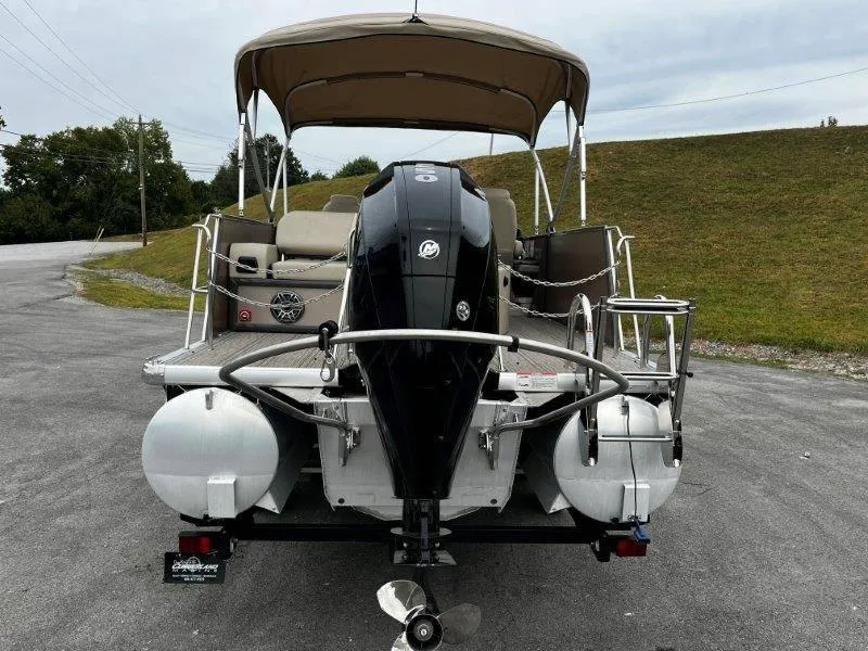 Slide: The Image of 2021 Premier 250 Grand Majestic pontoon boat with outboard motor, parked on pavement. - 25
