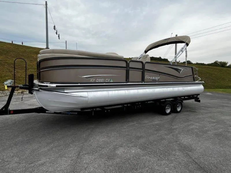 Slide: The Image of 2021 Premier 250 Grand Majestic pontoon boat on trailer, parked outdoors. - 29