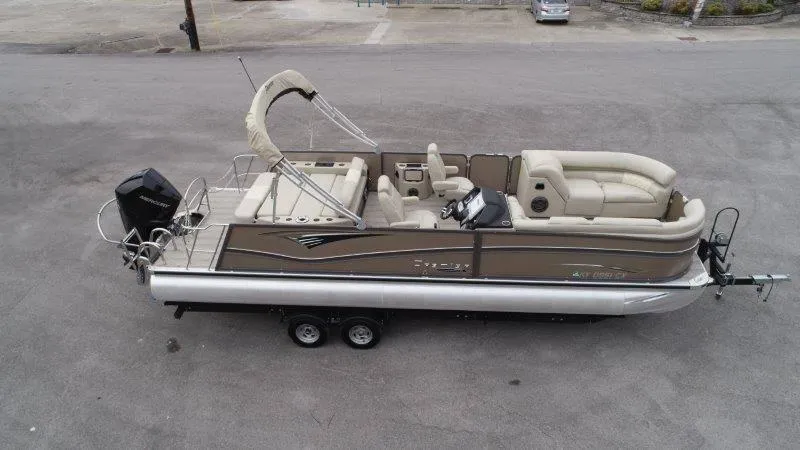 Slide: The Image of 2021 Premier 250 Grand Majestic pontoon boat with beige seating and outboard motor. - 3