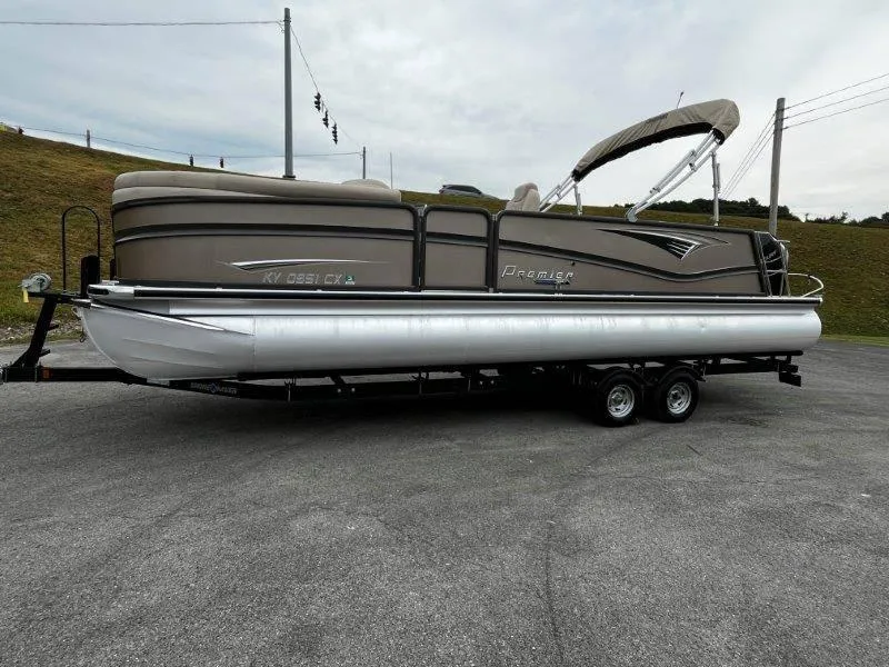 Slide: The Image of 2021 Premier 250 Grand Majestic pontoon boat on trailer, parked outdoors. - 31