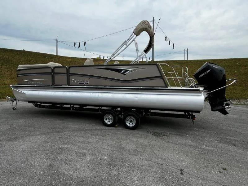 Slide: The Image of 2021 Premier 250 Grand Majestic pontoon boat on trailer, parked outdoors. - 36