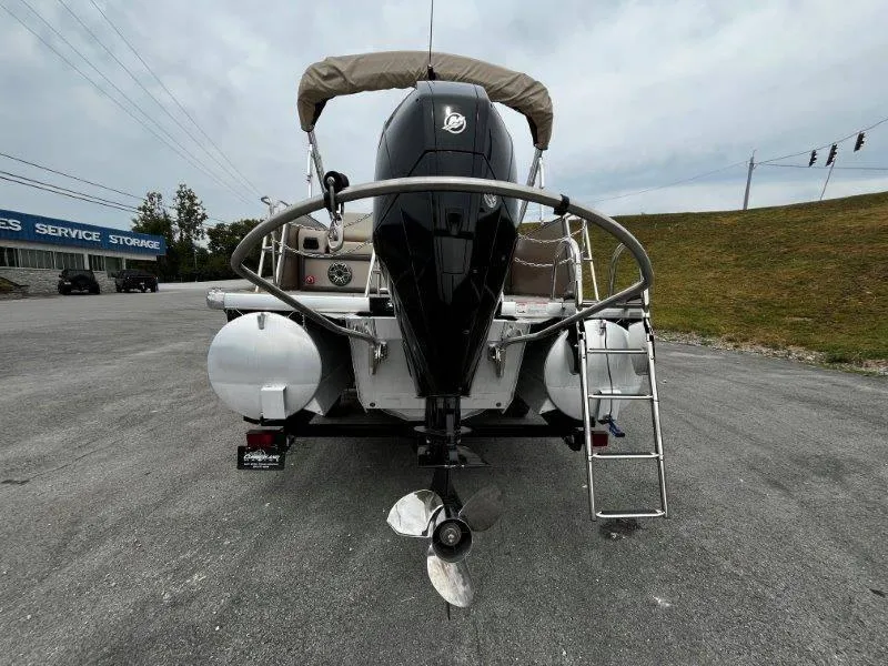 Slide: The Image of 2021 Premier 250 Grand Majestic pontoon boat rear view with outboard motor and ladder. - 39