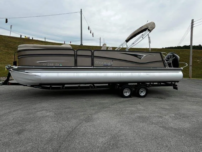 Slide: The Image of 2021 Premier 250 Grand Majestic pontoon boat on trailer, parked outdoors. - 43