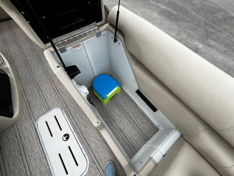 Slide: The Image of Storage compartment in 2021 Premier 250 Grand Majestic boat with blue and green container. - 47
