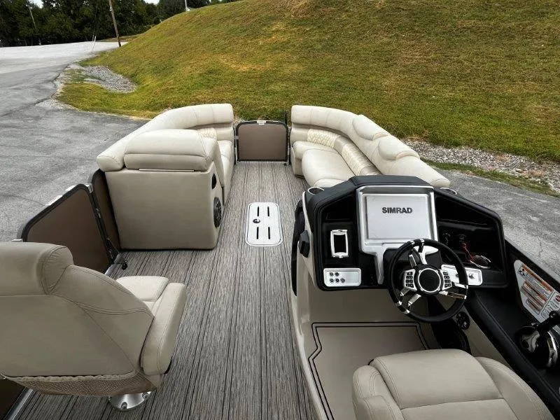 Slide: The Image of 2021 Premier 250 Grand Majestic pontoon boat interior with plush seating and modern dashboard. - 50
