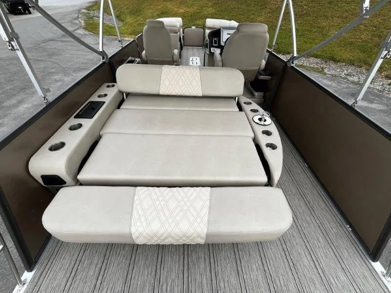 Slide: The Image of 2021 Premier 250 Grand Majestic boat interior with beige seating and cup holders. - 52