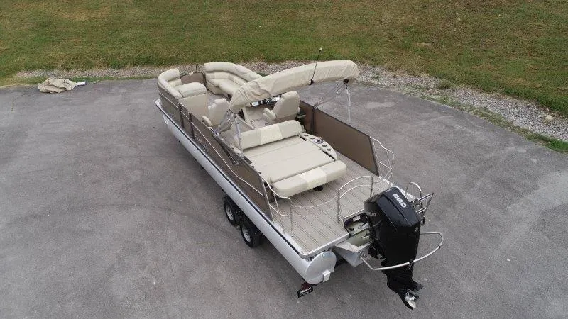 Slide: The Image of 2021 Premier 250 Grand Majestic pontoon boat with beige seating and outboard motor. - 9