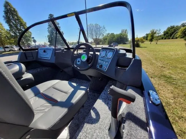 Slide: The Image of 2025 Tracker Pro Guide V-16 WT boat interior with steering wheel and dashboard controls. - 4