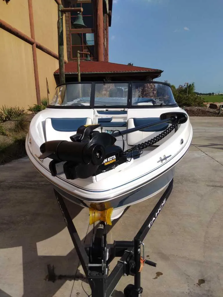 Slide: The Image of 2024 Tahoe 200 S boat on trailer, parked outdoors. - 1