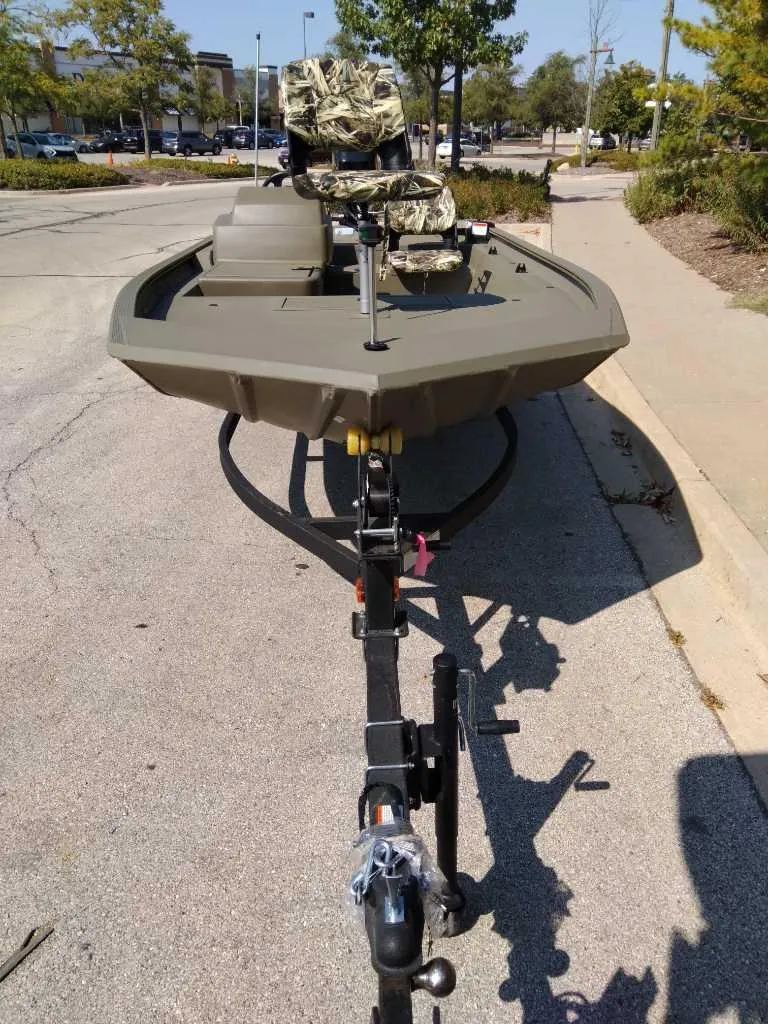 Slide: The Image of 2025 Tracker Grizzly 1754 SC boat on trailer, parked outdoors. - 2