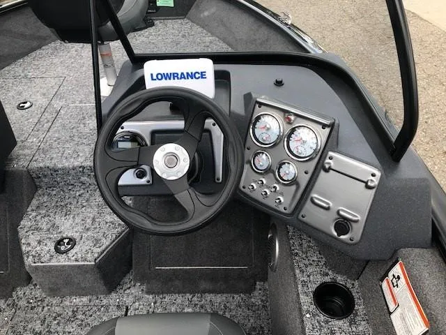 Slide: The Image of 2025 Tracker Pro Guide V-175 Combo boat dashboard with steering wheel and gauges. - 12