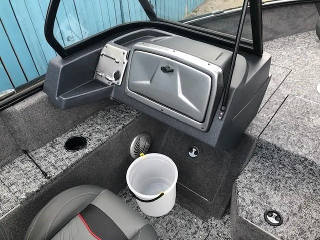 Slide: The Image of 2025 Tracker Pro Guide V-175 Combo boat interior with gray seating and storage compartments. - 13