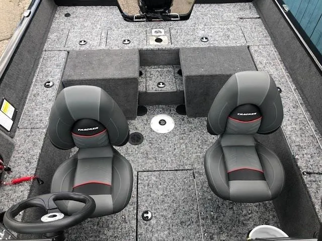 Slide: The Image of 2025 Tracker Pro Guide V-175 Combo boat interior with two gray seats and carpeted flooring. - 14