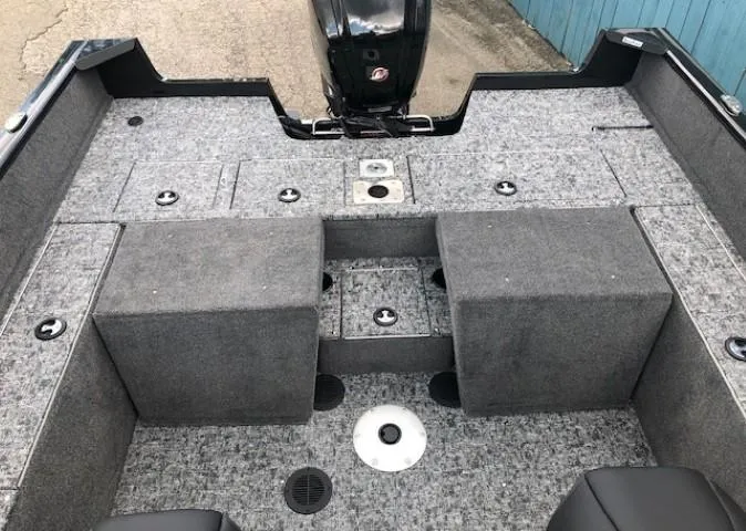 Slide: The Image of 2025 Tracker Pro Guide V-175 Combo boat interior with carpeted deck and storage compartments. - 17