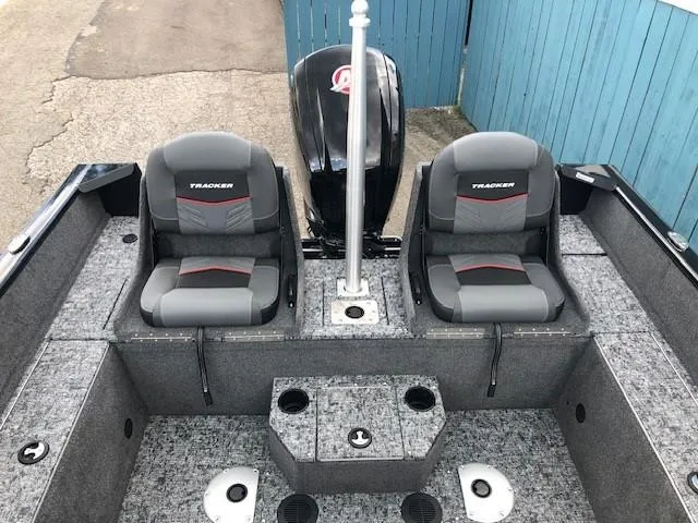 Slide: The Image of 2025 Tracker Pro Guide V-175 Combo boat interior with dual seats and storage compartments. - 21