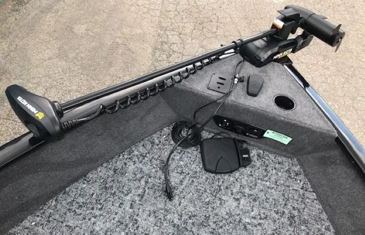 Slide: The Image of 2025 Tracker Pro Guide V-175 Combo boat interior with trolling motor and carpeted deck. - 7