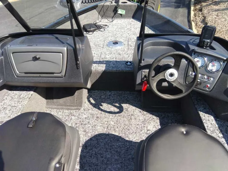 Slide: The Image of 2025 Tracker Pro Guide V-16 WT boat interior with steering wheel and dashboard. - 4