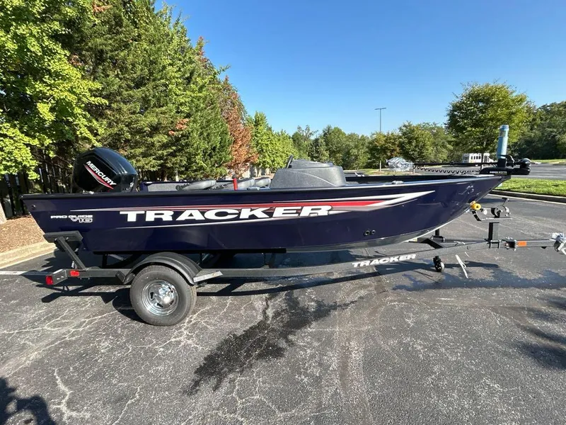 Slide: The Image of 2025 Tracker Pro Guide V-16 SC boat on trailer, parked outdoors. - 3