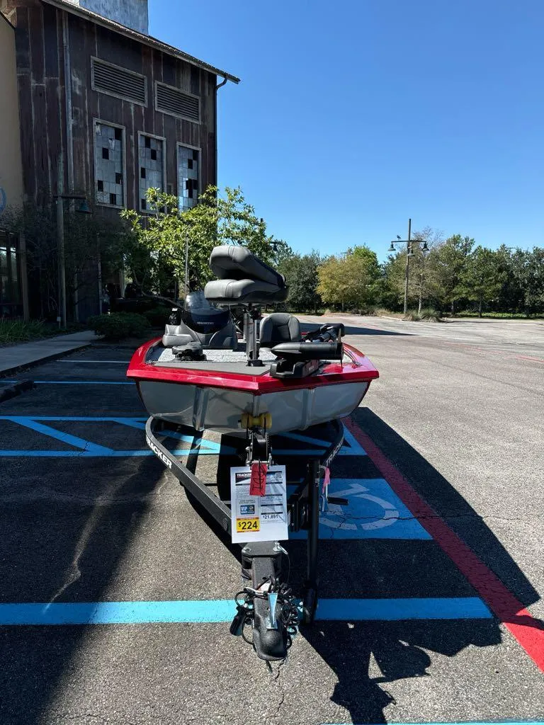 Slide: The Image of 2025 Tracker Pro 170 boat parked in a lot, front view, sunny day. - 3