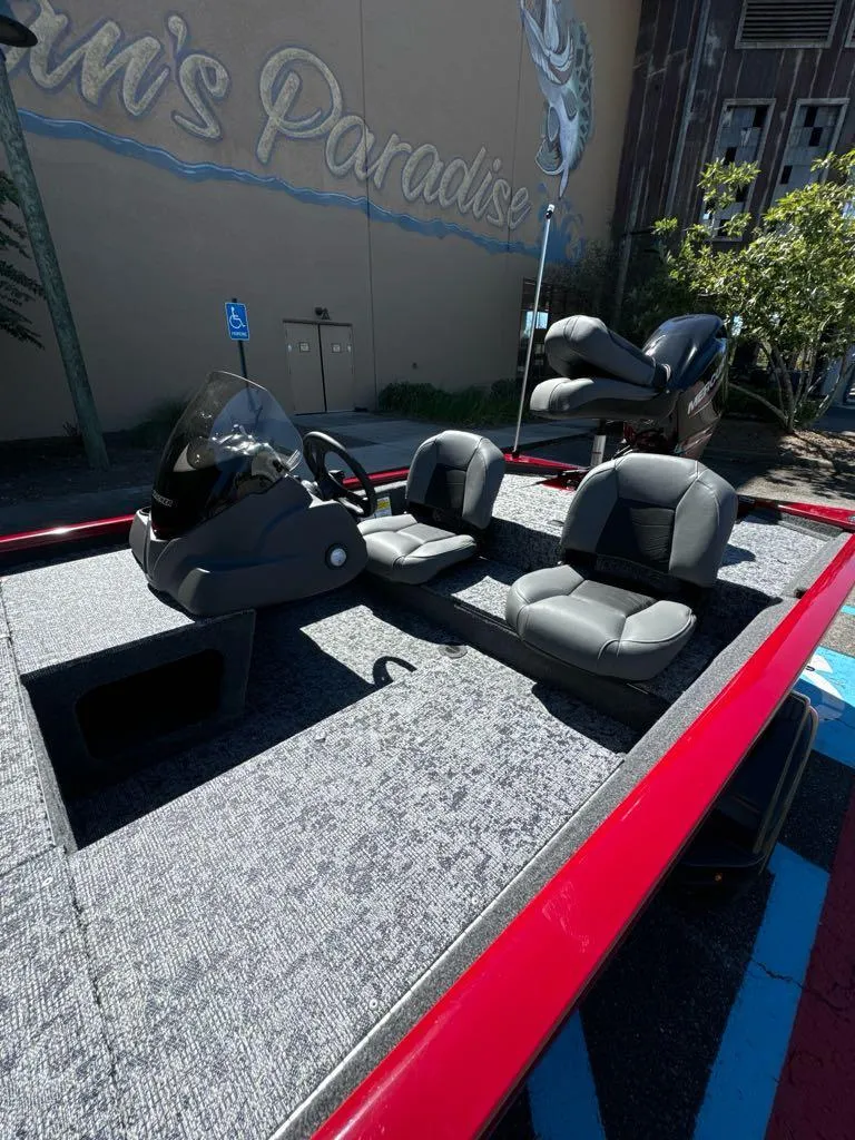 Slide: The Image of 2025 Tracker Pro 170 boat with dual seats and steering console, parked outdoors. - 5