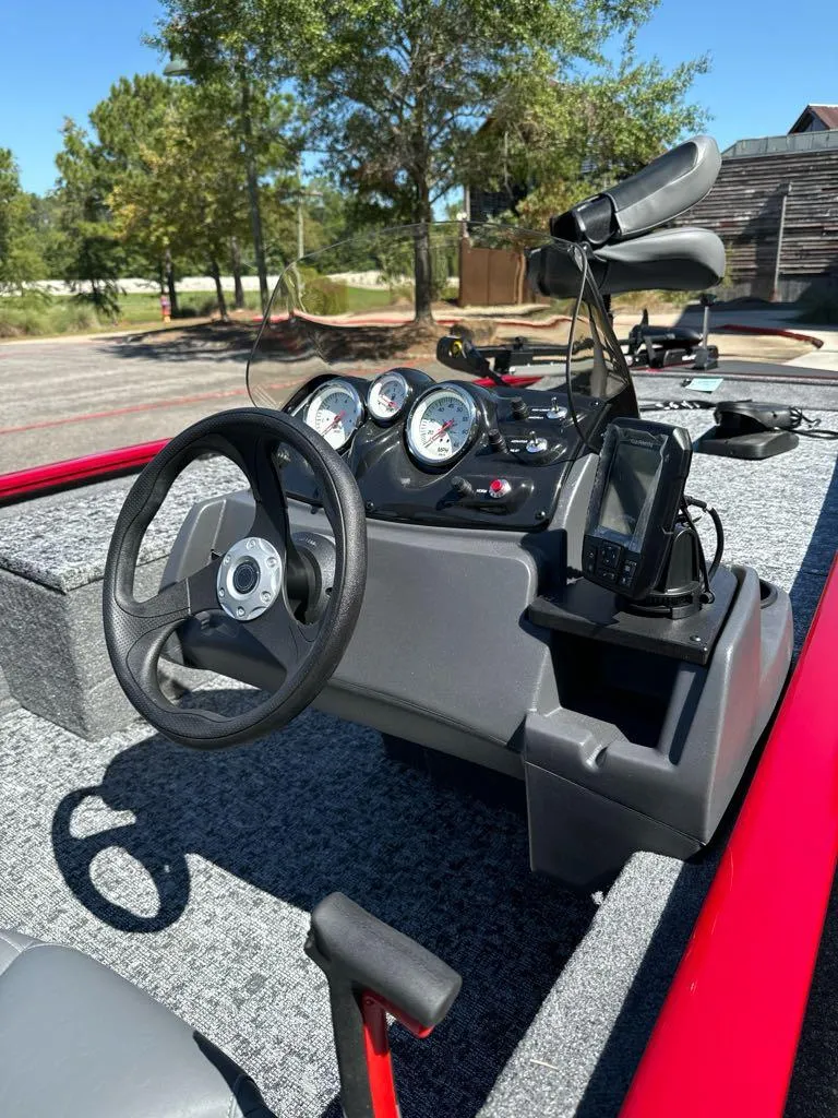 Slide: The Image of 2025 Tracker Pro 170 boat dashboard with steering wheel and gauges in outdoor setting. - 7