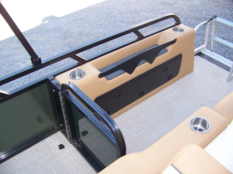Slide: The Image of 2025 Avalon Ven25VRB boat interior with beige seating, cup holders, and sleek railing design. - 12