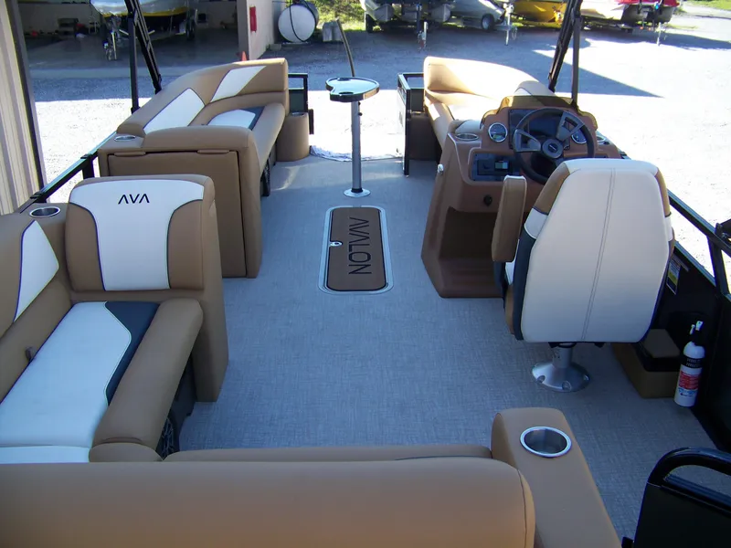 Slide: The Image of 2025 Avalon Ven25VRB boat interior with beige seating and modern dashboard. - 14