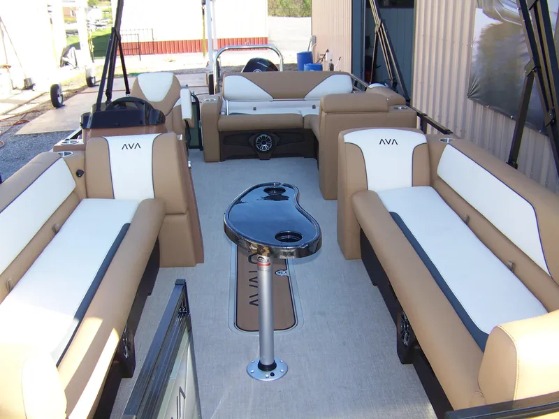 Slide: The Image of 2025 Avalon Ven25VRB pontoon boat interior with beige and white seating, central table, and cup holders. - 4